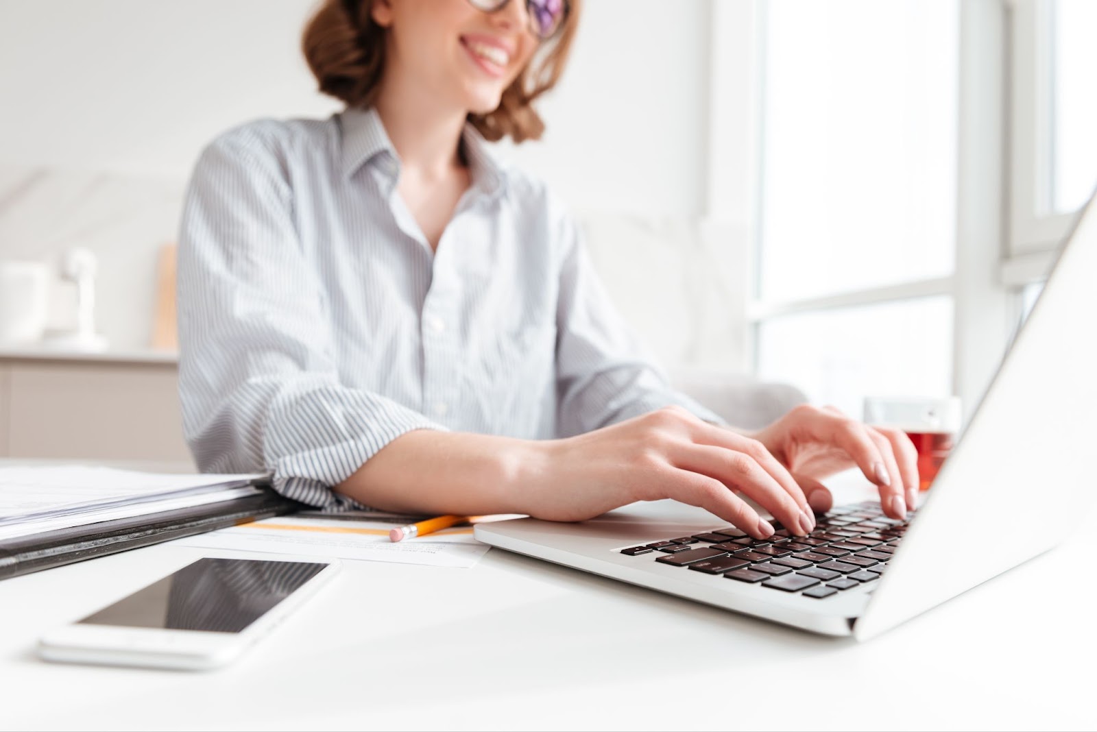 Close up of woman typing email on laptop