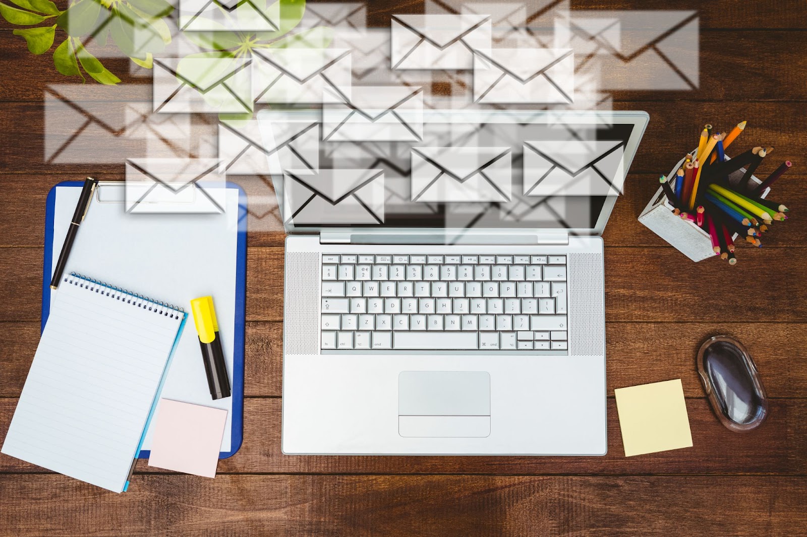 Top view of workdesk with envelopes and laptop